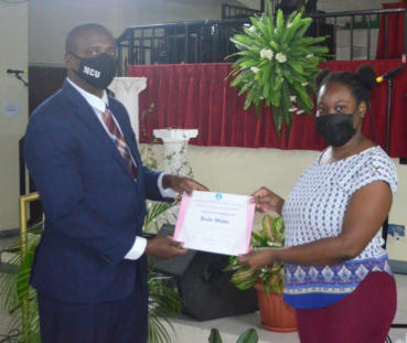 Guest Presenter, Damian Chambers, participating in the presentation of a certificate to team member, Joelle Walker